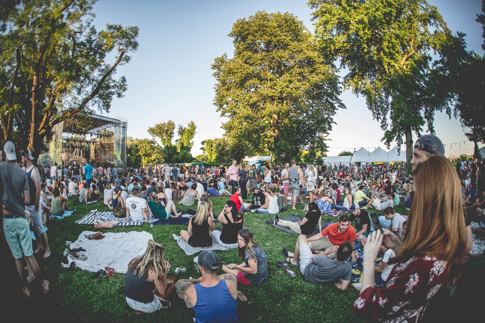 Guests sitting on lawn in front of Skyline Stage